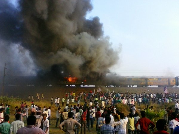 Violence broke out in Andhra Pradesh's East Godavari district on Sunday as thousands of protestors from Kapu caste set afire a train and blocked rail and road traffic. Kapus,Kapu Protesters,Kapu Protesters in Andhra,Andhra Pradesh,East Godavari,Kapu protest for Backward Class,train set on fire,Tuni in flames,Andhra Kapu quota stir takes violent,Violent Quota Protests In Andhra Pradesh