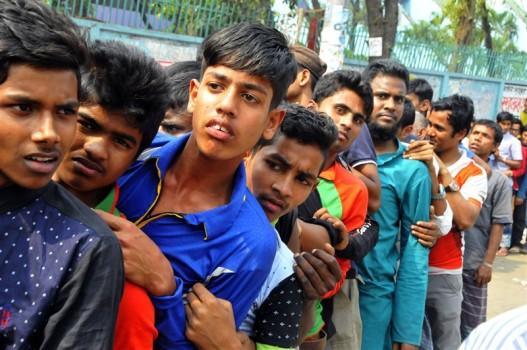 People stand in queue to buy tickets for India vs Pakistan cricket tournament.