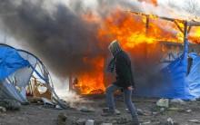 Clashes break out in Calais as police clear part of the shanty town in northern France.