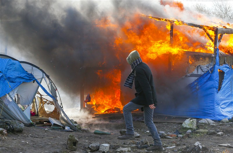 Clashes break out in Calais as police clear part of the shanty town in northern France. French Migrant,French Migrant Camp in Flames,Migrant jungle in flames,Migrant jungle,northern France,Calais Jungle,Shelters burn,French police