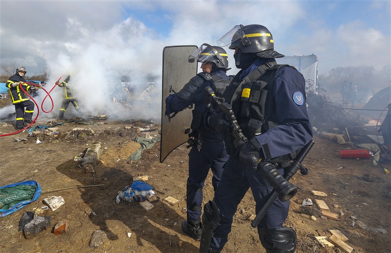 Clashes break out in Calais as police clear part of the shanty town in northern France. French Migrant,French Migrant Camp in Flames,Migrant jungle in flames,Migrant jungle,northern France,Calais Jungle,Shelters burn,French police