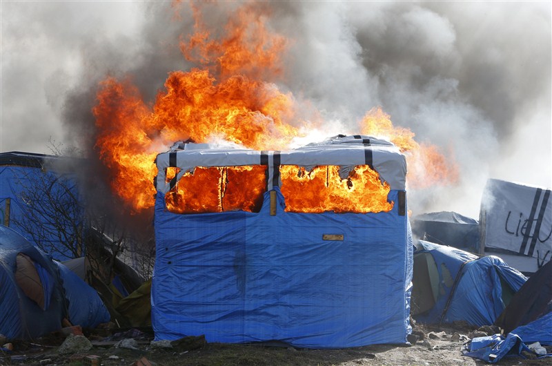 Clashes break out in Calais as police clear part of the shanty town in northern France. French Migrant,French Migrant Camp in Flames,Migrant jungle in flames,Migrant jungle,northern France,Calais Jungle,Shelters burn,French police