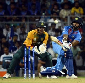 Star batsmen Jean-Paul Duminy and Quinton de Kock struck fluent half-centuries as South Africa registered a nail-biting, four run victory against India in the warm-up match ahead of the World Twenty20 cricket tournament at the Wankhede Stadium on Saturday.