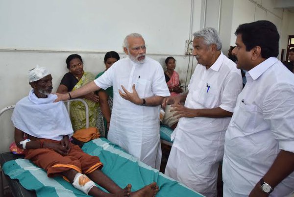 Prime Minister Narendra Modi arrived on Sunday afternoon and along with Chief Minister Oommen Chandy drove to the Puttingal Devi temple in Peravur town. Narendra Modi,Narendra Modi visits Kerala,Narendra Modi visits Kerala temple tragedy site,Modi visits Kerala temple,Puttingal Devi temple,Peravur town,Chief Minister Oommen Chandy,Oommen Chandy,Kerala chief minister oommen chandy
