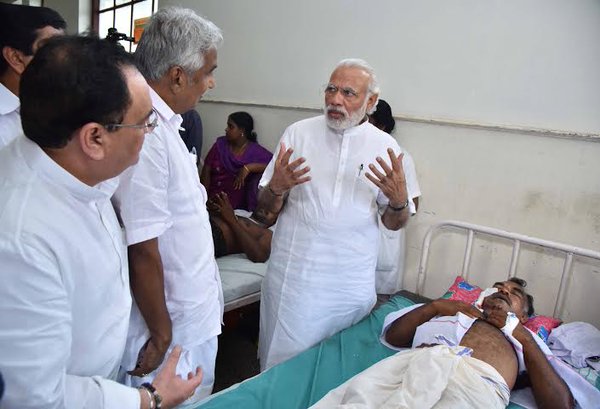 Prime Minister Narendra Modi arrived on Sunday afternoon and along with Chief Minister Oommen Chandy drove to the Puttingal Devi temple in Peravur town. Narendra Modi,Narendra Modi visits Kerala,Narendra Modi visits Kerala temple tragedy site,Modi visits Kerala temple,Puttingal Devi temple,Peravur town,Chief Minister Oommen Chandy,Oommen Chandy,Kerala chief minister oommen chandy