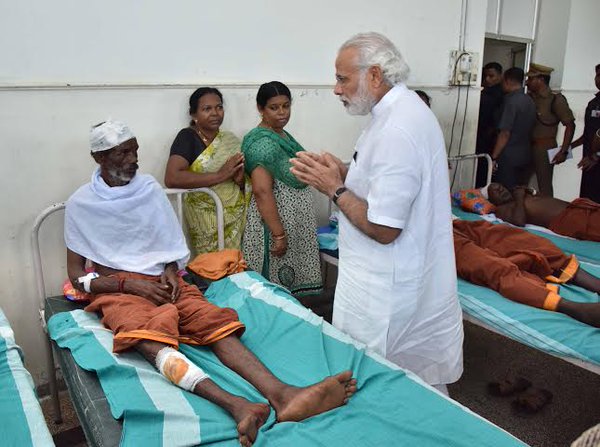 Prime Minister Narendra Modi arrived on Sunday afternoon and along with Chief Minister Oommen Chandy drove to the Puttingal Devi temple in Peravur town. Narendra Modi,Narendra Modi visits Kerala,Narendra Modi visits Kerala temple tragedy site,Modi visits Kerala temple,Puttingal Devi temple,Peravur town,Chief Minister Oommen Chandy,Oommen Chandy,Kerala chief minister oommen chandy