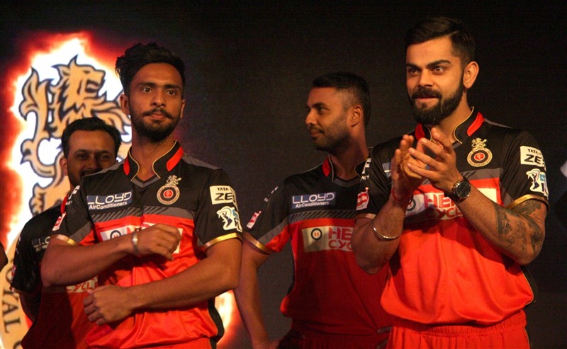 Indian Premier League (IPL) cricket team Royal Challengers Bangalore (RCB) unveiled on Friday an all new black and red jersey with two designs for home and away matches. RCB unveils new jersey,RCB unveils new jersey with two designs,Royal Challengers Bangalore,Royal Challengers Bangalore new jersey,Virat Kohli,Chris Gayle,Virat Kohli and Chris Gayle