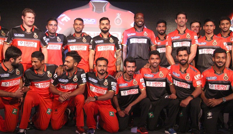 Indian Premier League (IPL) cricket team Royal Challengers Bangalore (RCB) unveiled on Friday an all new black and red jersey with two designs for home and away matches. RCB unveils new jersey,RCB unveils new jersey with two designs,Royal Challengers Bangalore,Royal Challengers Bangalore new jersey,Virat Kohli,Chris Gayle,Virat Kohli and Chris Gayle
