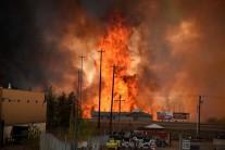 Fire rages unchecked in the heart of Canada's oil sands region as authorities race to evacuate 80,000 people.