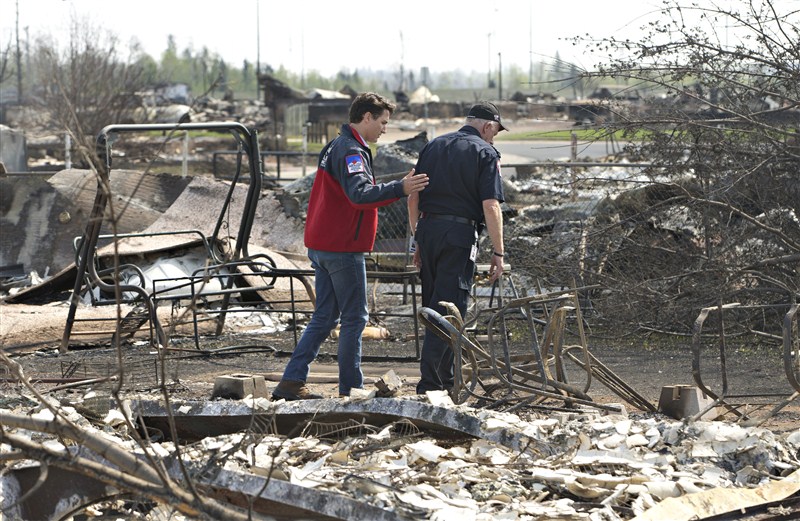 Canada's Prime Minister Justin Trudeau surveys the devastation in Fort McMurray after wildfires tore through the area. Trudeau visits Fort McMurray,Justin Trudeau,Prime Minister Justin Trudeau,Fort McMurray,Trudeau at Fort McMurray