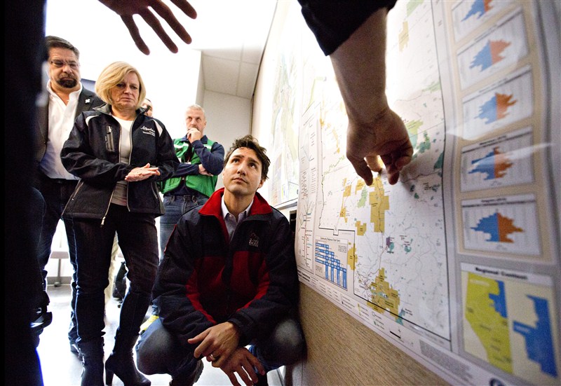 Canada's Prime Minister Justin Trudeau surveys the devastation in Fort McMurray after wildfires tore through the area. Trudeau visits Fort McMurray,Justin Trudeau,Prime Minister Justin Trudeau,Fort McMurray,Trudeau at Fort McMurray