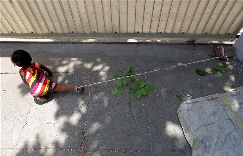 A toddler is tied to a rock in the searing heat, while her parents work at a construction site for $3.80 each a day in India. Toddler,Toddler tied to rock,Toddler tied to rock while parents work,Toddler tied,Toddler tied to stone,construction