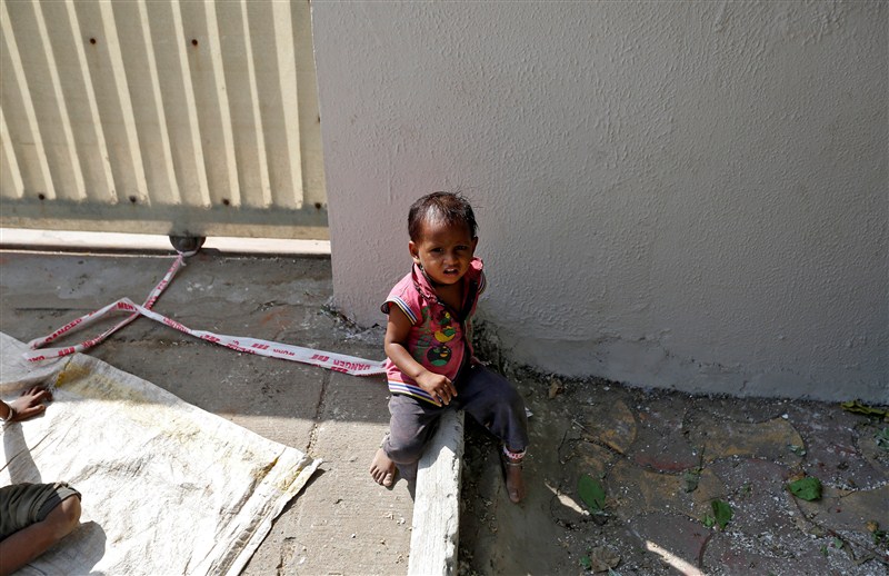 A toddler is tied to a rock in the searing heat, while her parents work at a construction site for $3.80 each a day in India. Toddler,Toddler tied to rock,Toddler tied to rock while parents work,Toddler tied,Toddler tied to stone,construction
