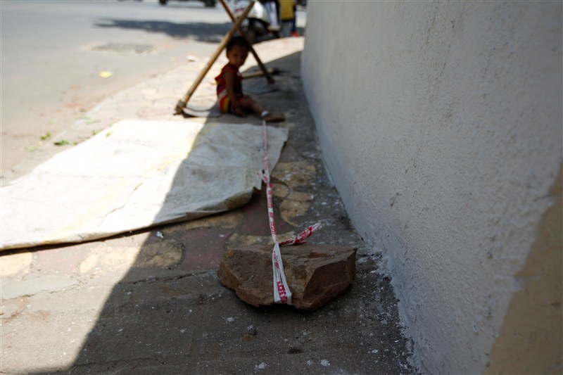 A toddler is tied to a rock in the searing heat, while her parents work at a construction site for $3.80 each a day in India. Toddler,Toddler tied to rock,Toddler tied to rock while parents work,Toddler tied,Toddler tied to stone,construction