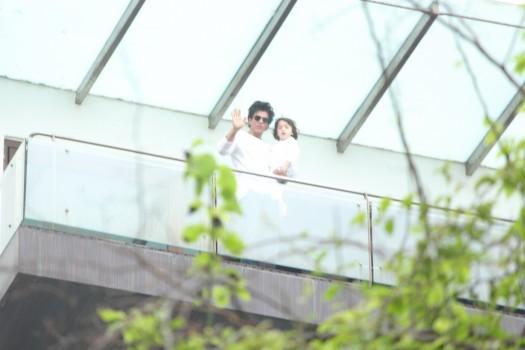 Bollywood actor Shah Rukh Khan, son AbRam greet fans on Eid at Mannat.
