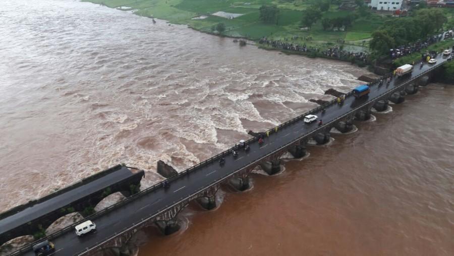 At least two buses with about 22 passengers were washed away early on Wednesday in flood waters after a bridge collapse on the Mumbai-Goa Highway, an official said. Mumbai-Goa highway bridge collapse,bridge collapse,highway bridge collapse,flood waters,bridge collapse in Mumbai-Goa Highway,bridge collapse in Mumbai Highway,bridge collapse in Goa Highway