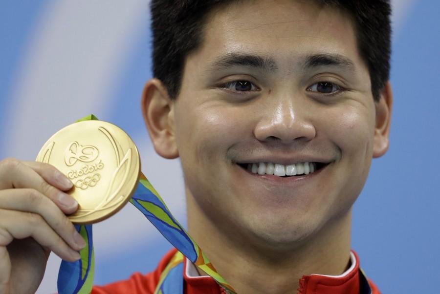 Joseph Schooling won Singapore's first gold medal of the ongoing Rio Olympics by ending multiple Olympic gold medallist Michael Phelps hegemony in the 100m butterfly here. The 21-year-old Schooling touched the wall in 50.39 seconds, 0.75sec ahead of Phelps at the Olympic Aquatics Stadium here on Friday evening, reports Xinhua. Joseph Schooling,Michael Phelps,Joseph Schooling beats Michael Phelps,Rio Olympics,Rio Olympics 2016