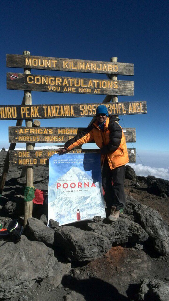 Malavath Poorna, a tribal girl from Telangana who came into prominence after becoming the youngest girl in the world to scale Mount Everest two years ago, climbed Mount Kilimanjaro to unveil the first look of her biopic Poorna,Poorna first look,Poorna poster,Poorna unveiled on Mount Kilimanjaro,Mount Kilimanjaro,Bollywood movie Poorna