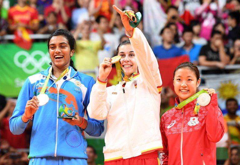 Indian shuttler P.V. Sindhu settled for silver at the Rio Olympics after being beaten 21-19, 12-21, 15-21 by World No.1 Carolina Marin of Spain in the badminton women's singles event here on Friday. P.V. Sindhu,shuttler P.V. Sindhu,Indian shuttler P.V. Sindhu,Carolina Marin,PV Sindhu vs Carolina Marin,badminton women's singles