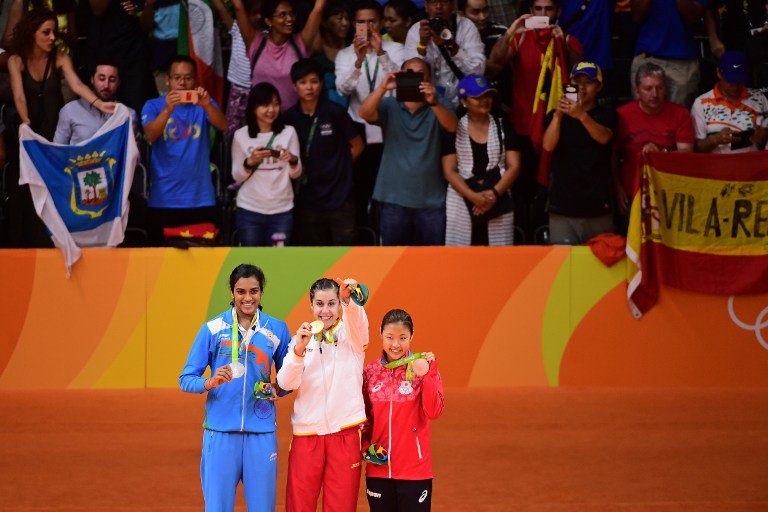 Indian shuttler P.V. Sindhu settled for silver at the Rio Olympics after being beaten 21-19, 12-21, 15-21 by World No.1 Carolina Marin of Spain in the badminton women's singles event here on Friday. P.V. Sindhu,shuttler P.V. Sindhu,Indian shuttler P.V. Sindhu,Carolina Marin,PV Sindhu vs Carolina Marin,badminton women's singles