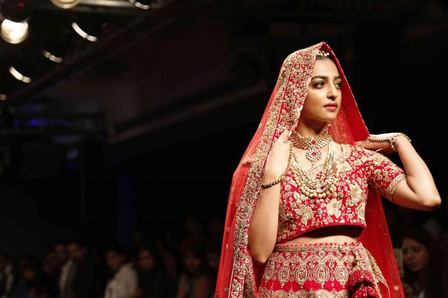 Actress Radhika Apte played muse to Kolkata-based designer Saroj Jalan, at the Lakme Fashion Week (LFW) Winter/Festive 2016 and she looked no less than a bride in a red lehenga teamed up with a maang tikka. Radhika Apte,Radhika Apte at Lakme Fashion Week Winter Festive 2016,Radhika Apte at Lakme Fashion Week,Lakme Fashion Week,Lakme Fashion Week 2016,Radhika Apte shines in 'near weightless',Radhika Apte pics,Radhika Apte images,Radhika Apte photos