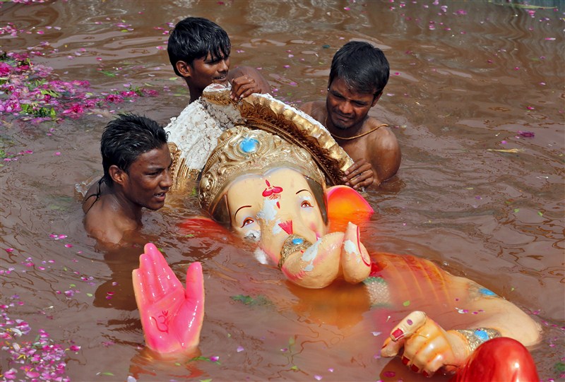 Devotees carry an idol of the Hindu god Ganesh, the deity of prosperity, into the Arabian Sea on the second day of Ganesh Chaturthi festival in in Mumbai. Ganesh Visarjan,Lord Ganesh Visarjan,Ganesh Visarjan 2016,Ganesh Visarjan pics,Ganesh Visarjan images,Ganesh Visarjan photos,Ganesh Visarjan stills,Ganesh Visarjan pictures,Ganesh Chaturthi festival,Bye bye Ganesh Chaturthi