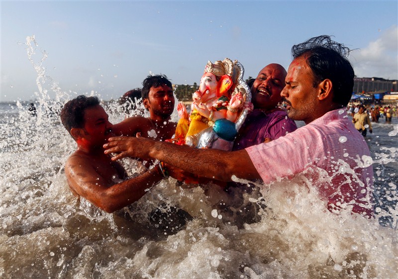 Devotees carry an idol of the Hindu god Ganesh, the deity of prosperity, into the Arabian Sea on the second day of Ganesh Chaturthi festival in in Mumbai. Ganesh Visarjan,Lord Ganesh Visarjan,Ganesh Visarjan 2016,Ganesh Visarjan pics,Ganesh Visarjan images,Ganesh Visarjan photos,Ganesh Visarjan stills,Ganesh Visarjan pictures,Ganesh Chaturthi festival,Bye bye Ganesh Chaturthi