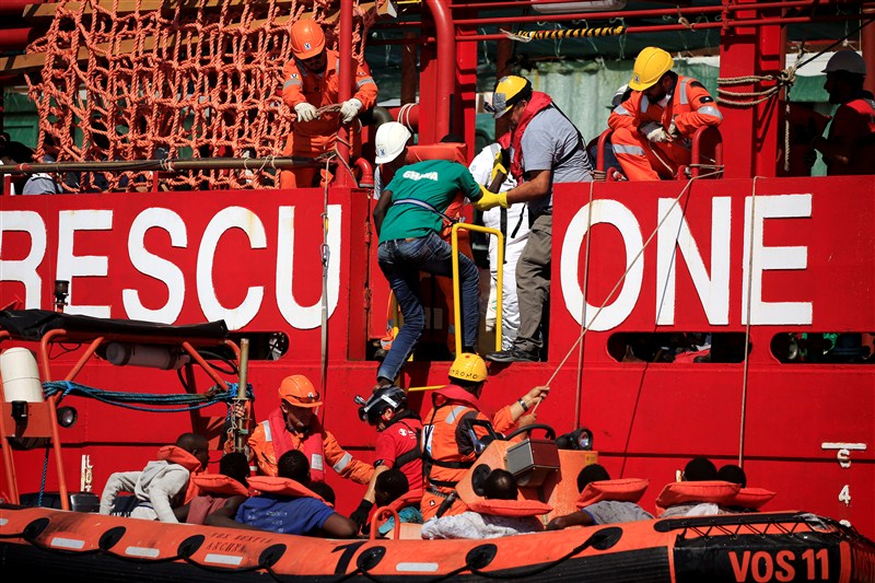Migrants from African countries are rescued from an overcrowded dinghy off the Libyan coast in the Mediterranean Sea. Migrants from African countries,African countries,Migrants,Libyan coast,Mediterranean Sea,Migrants plucked from overloaded dinghy,Sicilian port