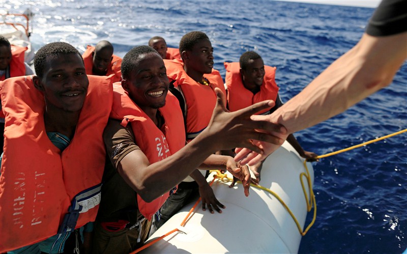 Migrants from African countries are rescued from an overcrowded dinghy off the Libyan coast in the Mediterranean Sea. Migrants from African countries,African countries,Migrants,Libyan coast,Mediterranean Sea,Migrants plucked from overloaded dinghy,Sicilian port