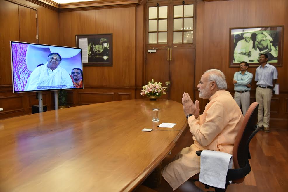 PM Narendra Modi interacts with Mata Amritanandamayi 'Amma' through video conferencing. Narendra Modi,Modi,Mata Amritanandamayi,Amma,Modi interacts with Mata Amritanandamayi,Modi interacts with Amma,Modi and Mata Amritanandamayi,Modi and Amma