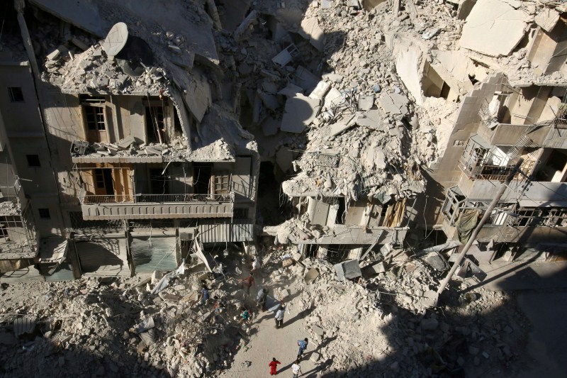 People dig in the rubble in an ongoing search for survivors at a site hit previously by an airstrike in the rebel-held Tariq al-Bab neighborhood of Aleppo. Air strikes,rebel-held Syria,Syria conflict,Syrian government forces,Syrian army,Air strikes pound rebel-held Aleppo