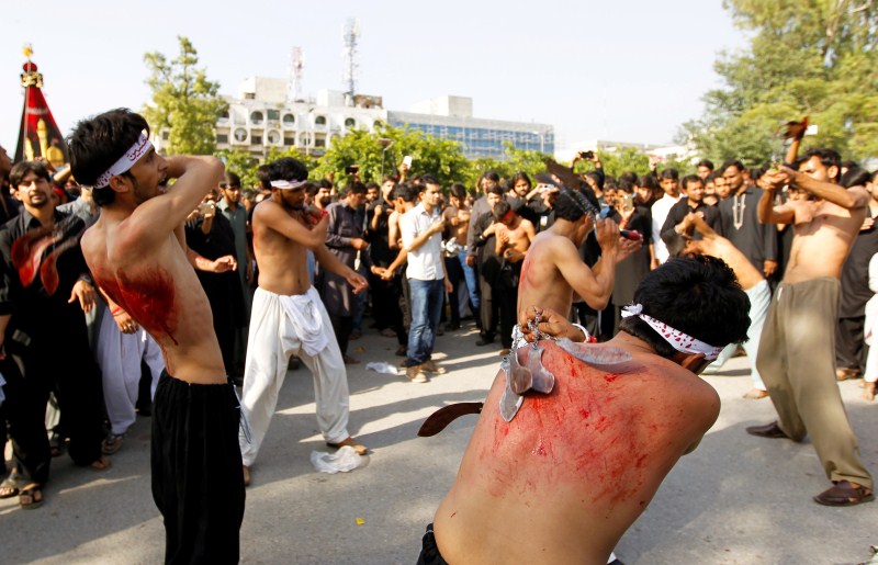 Men participate in self flagellation during the Shi'ite Muharram procession in Islamabad, Pakistan. Muharram,Muharram procession,Muharram procession in Peshawar,Men participate in Muharram procession,Muharram procession pics,Muharram procession images,Muharram procession photos,Muharram procession stills,Muharram procession pictures,Muharram celebration