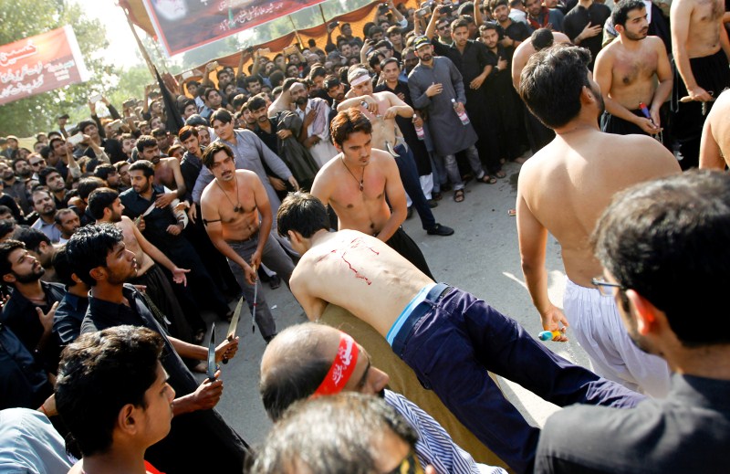 A man is carried away after self flagellation during the Shi'ite Muharram procession in Islamabad, Pakistan. Muharram,Muharram procession,Muharram procession in Peshawar,Men participate in Muharram procession,Muharram procession pics,Muharram procession images,Muharram procession photos,Muharram procession stills,Muharram procession pictures,Muharram celebration