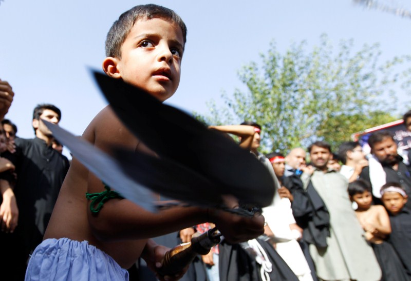 A child participates in self flagellation during the Shi'ite Muharram procession in Islamabad, Pakistan. Muharram,Muharram procession,Muharram procession in Peshawar,Men participate in Muharram procession,Muharram procession pics,Muharram procession images,Muharram procession photos,Muharram procession stills,Muharram procession pictures,Muharram celebration