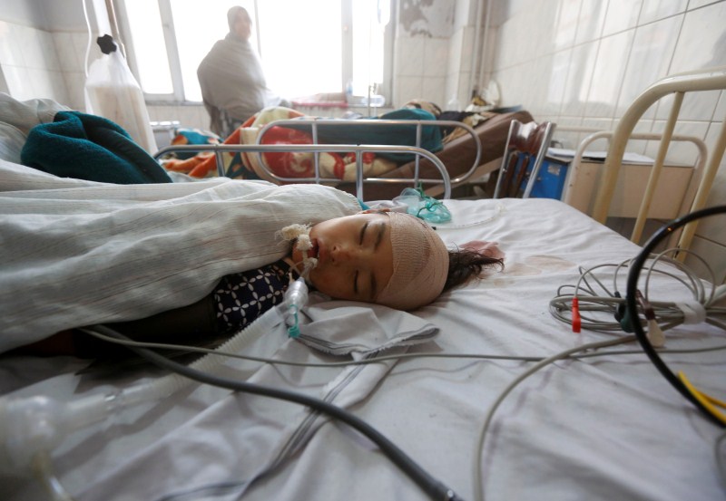 An Afghan girl receives treatment at a hospital after a gunman attacked a shrine in Kabul, Afghanistan. Islamic State claimed responsibility for a mass shooting that killed at least 18 worshippers at a shrine in the Afghan capital on Tuesday, raising fears of sectarian violence after a string of attacks on the country's Shi'ite minority. Attacks on Afghan mosques,Afghan mosques,Attacks on mosques,Shi'ite Muslims,Ashura,Mazar-i-Sharif,Bomb Blast mosque,Bomb Blast,mosque Bomb Blast