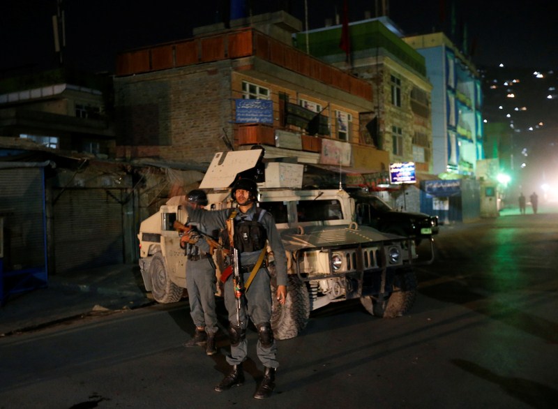 Afghan policemen stand guard near the site of an attack in Kabul, Afghanistan. The claim to Tuesday's attack, released online, came as the community observed Ashura, one of its holiest days, although commemorations have been subdued because of security fears. Attacks on Afghan mosques,Afghan mosques,Attacks on mosques,Shi'ite Muslims,Ashura,Mazar-i-Sharif,Bomb Blast mosque,Bomb Blast,mosque Bomb Blast