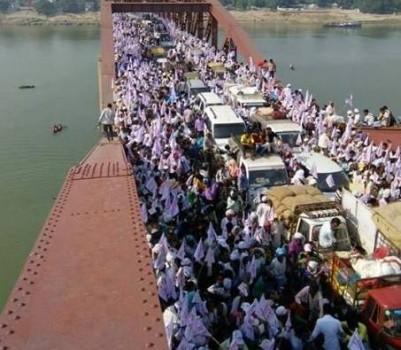 At least 18 persons, including women, were killed and hundreds injured in a stampede at a religious gathering in Varanasi on Saturday, police said.