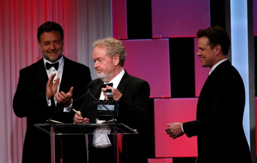 Director Ridley Scott accepts the American Cinematheque Award, as actors Russell Crowe (L) and Matt Damon stand nearby. 30th Annual American Cinematheque Award,Annual American Cinematheque Award,Sigourney Weaver,Matt Damon,Kristen Wiig,Bradley Cooper,Sonia Braga,Russell Crowe,Andy Garcia,Ben Kingsley,Director Ridley Scott