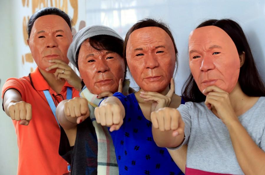 Students wearing Halloween masks depicting President Rodrigo Duterte raise their clenched fists, a signature gesture of Duterte, at the college of fine arts of the University of the Philippines in Quezon city, metro Manila, Philippines. Halloween creative masks,Halloween masks,Halloween Masks,Halloween funny Masks,Halloween scary Masks,Printable Halloween Masks