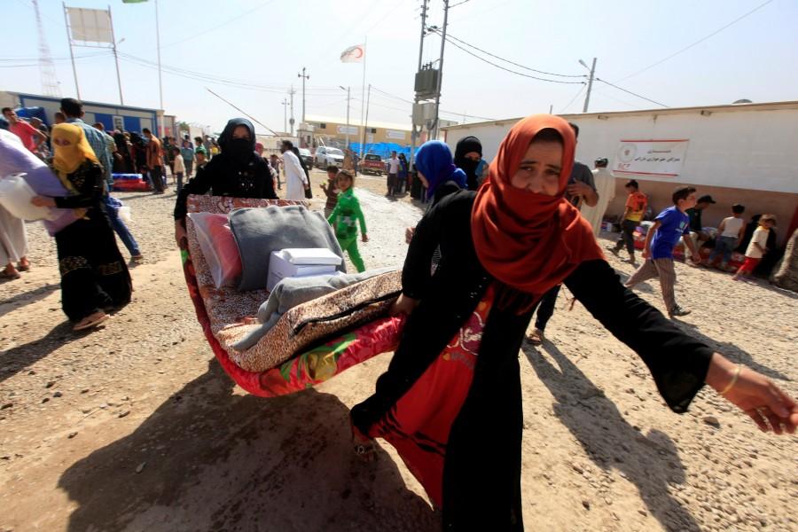 Displaced people who fled Islamic State militants from Mosul receive aid at Deepaka camp in the northwest of Erbil, Iraq. Mosul,Iraqi forces,Islamic State,assault on Mosul,Mosul offensive,Mosul civilians,Fleeing Mosul,Assault on ISIS in Mosul,Assault on ISIS,ISIS