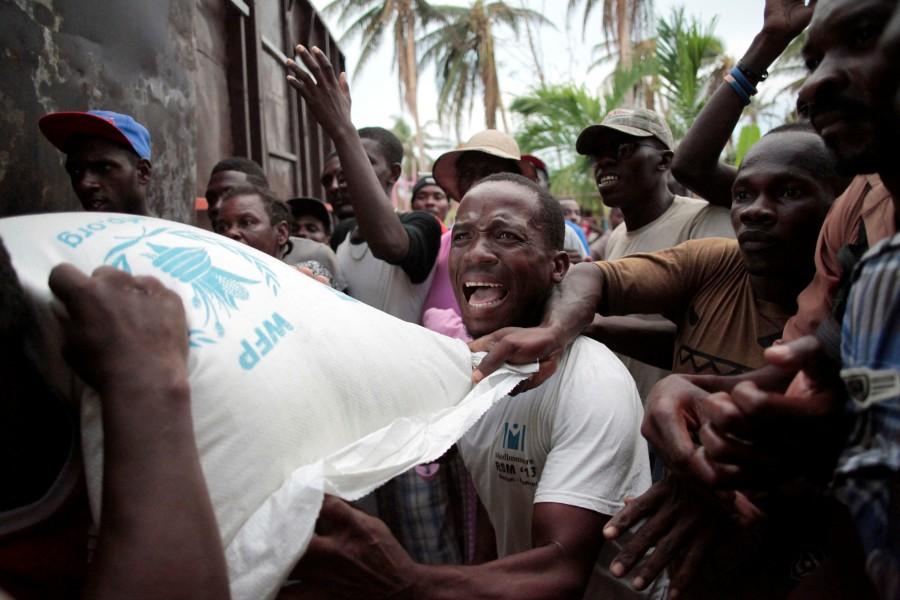 Residents try to get a sack of rice, after a distribution was rescheduled and food stored, following Hurricane Matthew in Saint Jean du Sud, Haiti. Haiti,Hurricane Matthew,Hurricane,acter Hurricane Matthew