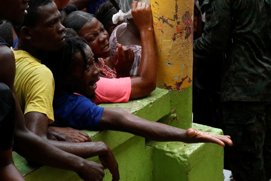 People wait for food to be handed out after Hurricane Matthew hit Jeremie, Haiti. Haiti,Hurricane Matthew,Hurricane,acter Hurricane Matthew