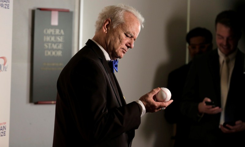 Actor, comedian and Chicago Cubs fan Bill Murray look at a baseball as he arrives to receive the 19th annual Mark Twain Prize for American Humor at the Kennedy Center in Washington. Bill Murray,Mark Twain Prize,American Humor at the Kennedy Center,Kennedy Center,19th annual Mark Twain Prize,Bill Murray awarded Mark Twain Prize