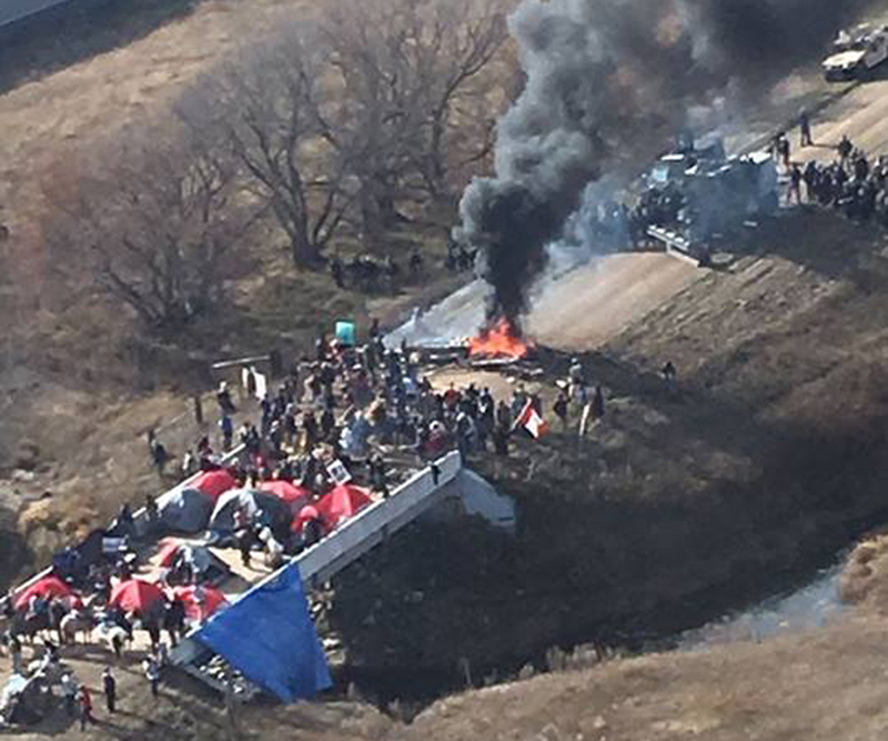 Protestors against the Dakota Access Pipeline stand-off with police in this aerial photo of Highway 1806 and County Road 134 near the town of Cannon Ball, North Dakota, U.S., October 27, 2016. North Dakota pipeline protest,pipeline protest,North Dakota protest,violent clashes,Dakota Access oil pipeline project,Dakota oil pipeline project,Native American