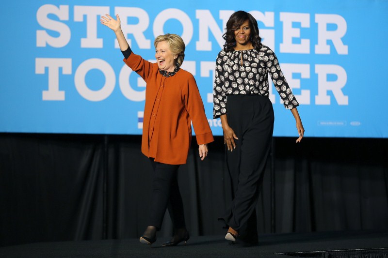 U.S. Democratic presidential candidate Hillary Clinton arrives to a campaign rally accompanied by U.S. first lady Michelle Obama in Winston-Salem, North Carolina, U.S., October 27, 2016. US election 2016,US election,Hillary Clinton,Michelle Obama,Hillary Clinton and Michelle Obama,First lady Michelle Obama,Michelle Obama campaigns with Clinton,Michelle Obama joins Hillary Clinton