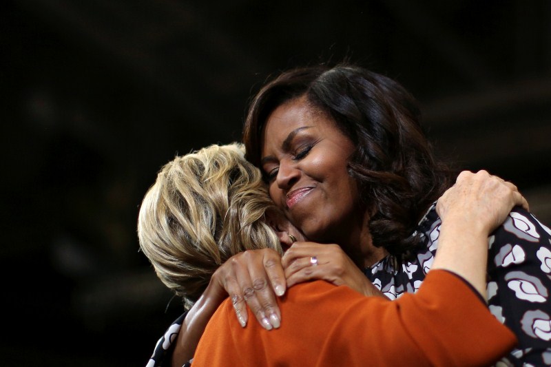 U.S. first lady Michelle Obama embraces U.S. Democratic presidential candidate Hillary Clinton as they arrive at a campaign rally in Winston-Salem, North Carolina, U.S. US election 2016,US election,Hillary Clinton,Michelle Obama,Hillary Clinton and Michelle Obama,First lady Michelle Obama,Michelle Obama campaigns with Clinton,Michelle Obama joins Hillary Clinton
