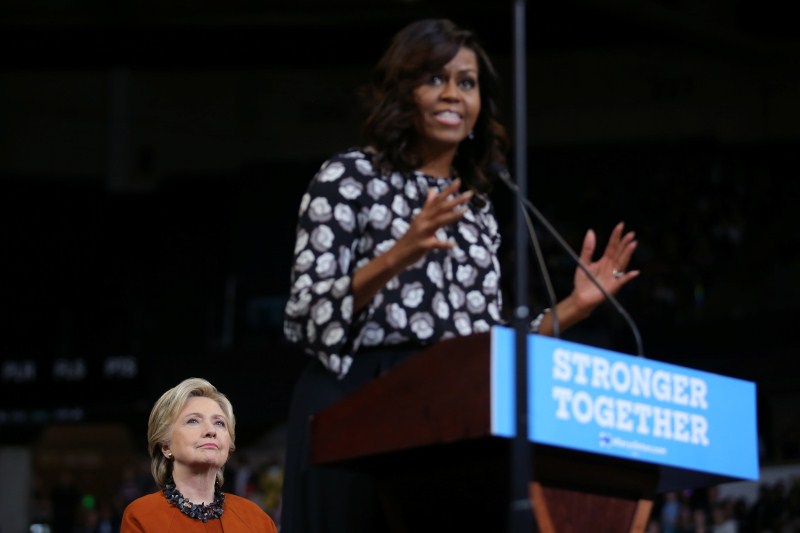 U.S. Democratic presidential candidate Hillary Clinton listens as U.S. First Lady Michelle Obama speaks during a campaign rally in Winston-Salem, North Carolina, U.S. US election 2016,US election,Hillary Clinton,Michelle Obama,Hillary Clinton and Michelle Obama,First lady Michelle Obama,Michelle Obama campaigns with Clinton,Michelle Obama joins Hillary Clinton