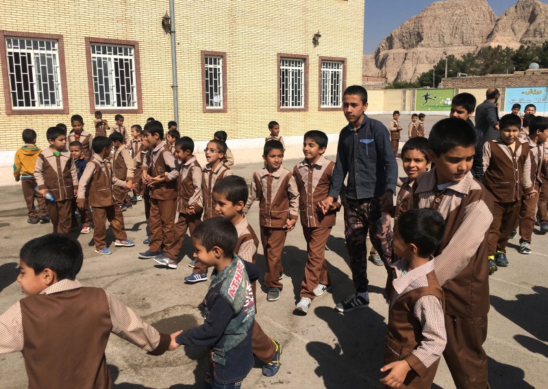 Iranian and Afghan boys play outside at the Be'sat school in Kerman, Iran. Afghan refugees,Afghan refugees in Iran,Soviet invasion,Taliban insurgency,Islamic State attacks,Islamic attacks,Afghans,Taliban,refugees,refugees in Iran,Islamic refugees attacks