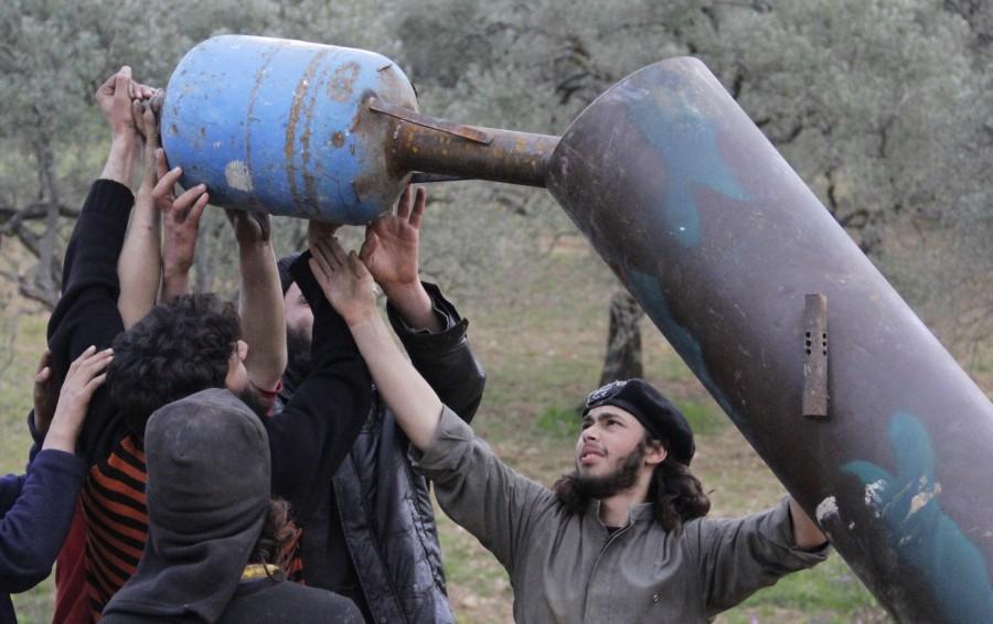 Rebel fighters from Suqour al-Sham Brigade prepare a locally made shell before launching it towards forces loyal to Syria's president Bashar Al-Assad in Idlib countryside. DIY weapons of Syria,Syria DIY weapons,Syrian tanks,Syrian missiles,Syrian mortars,Dahiyat al-Assad