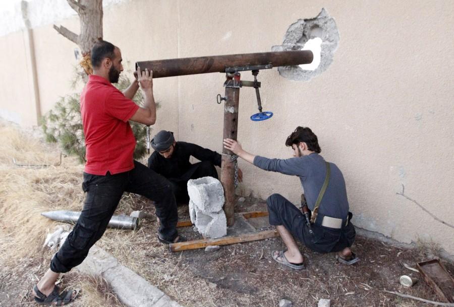 Free Syrian Army fighters prepare to fire rockets towards forces loyal to Syria's president Bashar al-Assad in Raqqa, eastern Syria. DIY weapons of Syria,Syria DIY weapons,Syrian tanks,Syrian missiles,Syrian mortars,Dahiyat al-Assad